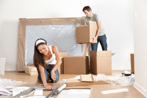 Professional movers handling office equipment and furniture carefully