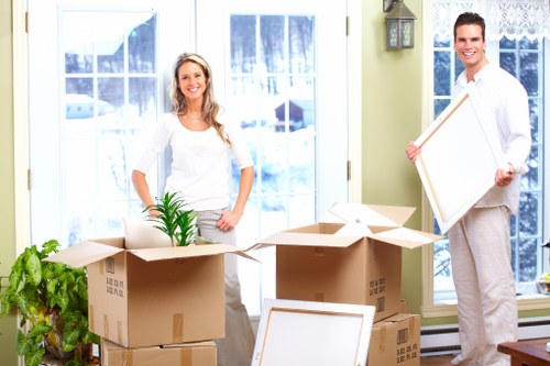 Removal team handling furniture and boxed belongings during a local move