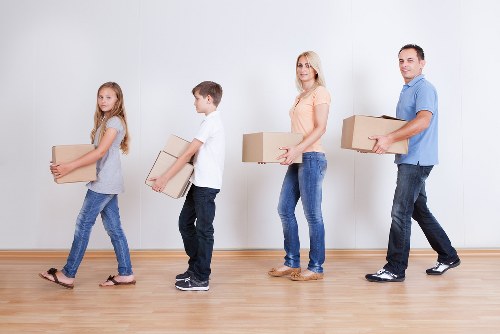 Professional movers working carefully with PPE during relocation